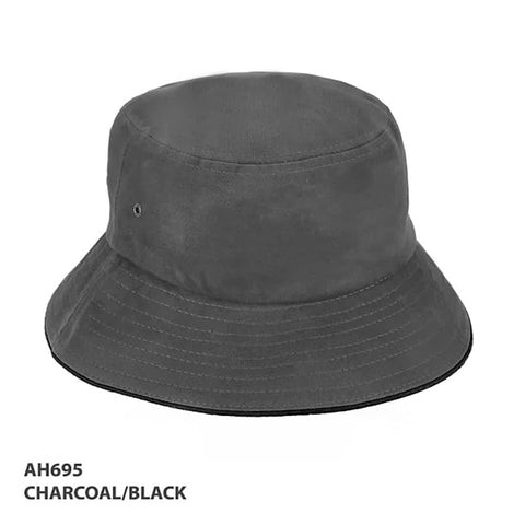 A charcoal and black bucket hat with a wide brim and metal eyelets, featuring a branding logo.