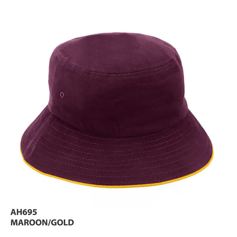 A maroon bucket hat with a gold trim and a logo on the side.